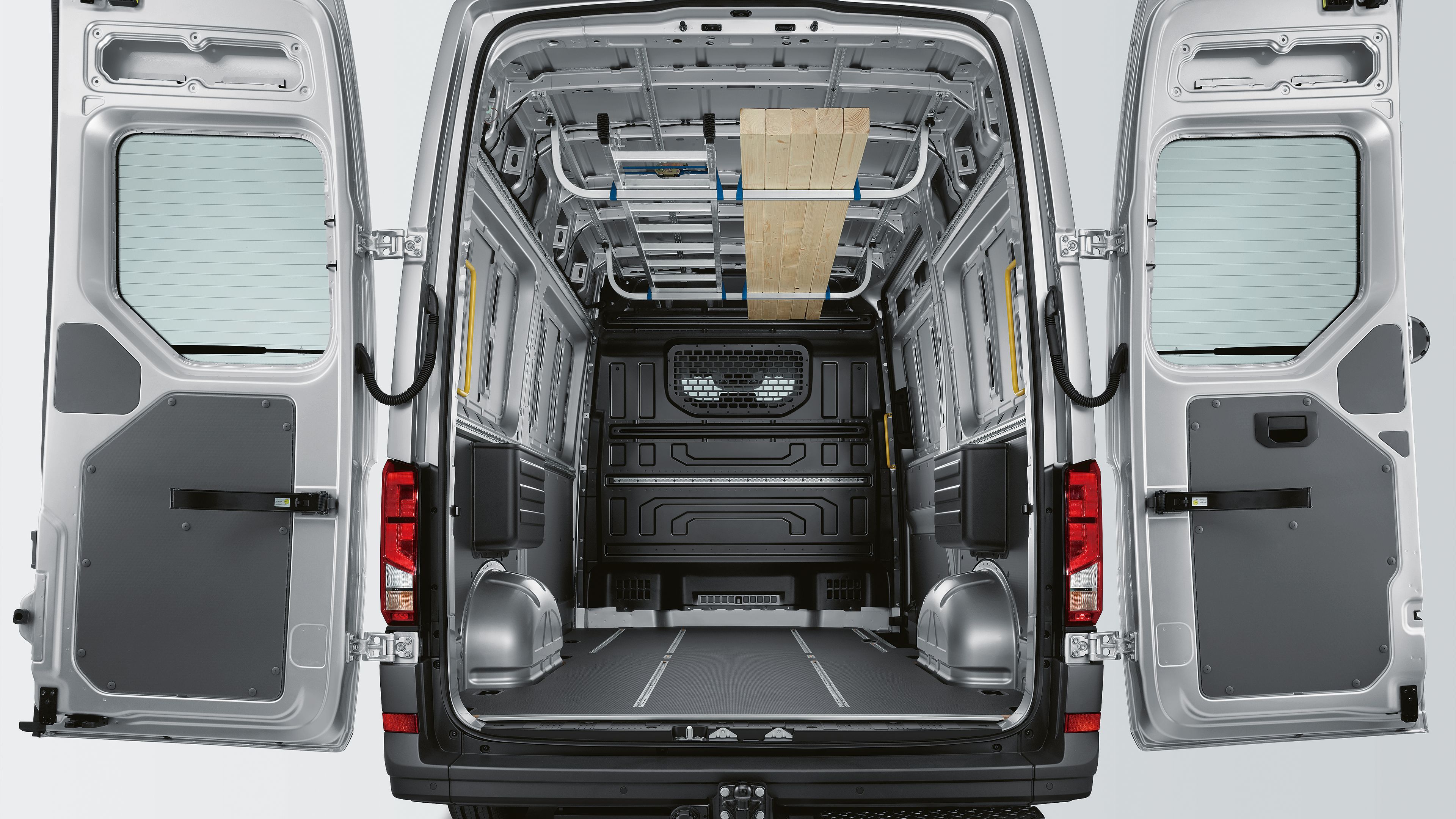 Ein Blick in den Laderaum des Volkswagen Nutzfahrzeuge Crafter Kastenwagen. Darin ist die Trennwand mit Fenster und Schutzgitter zu sehen.
